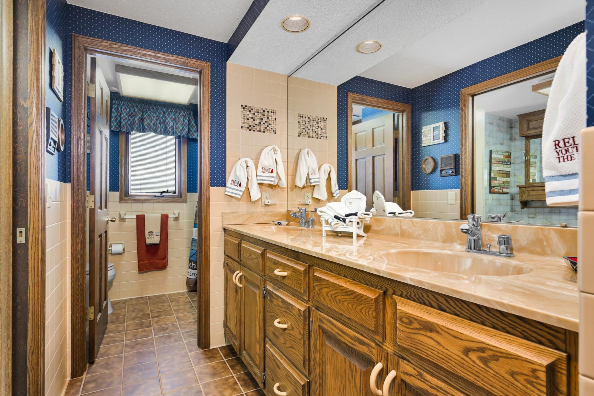 Lower-level 3/4 bath with double sinks.