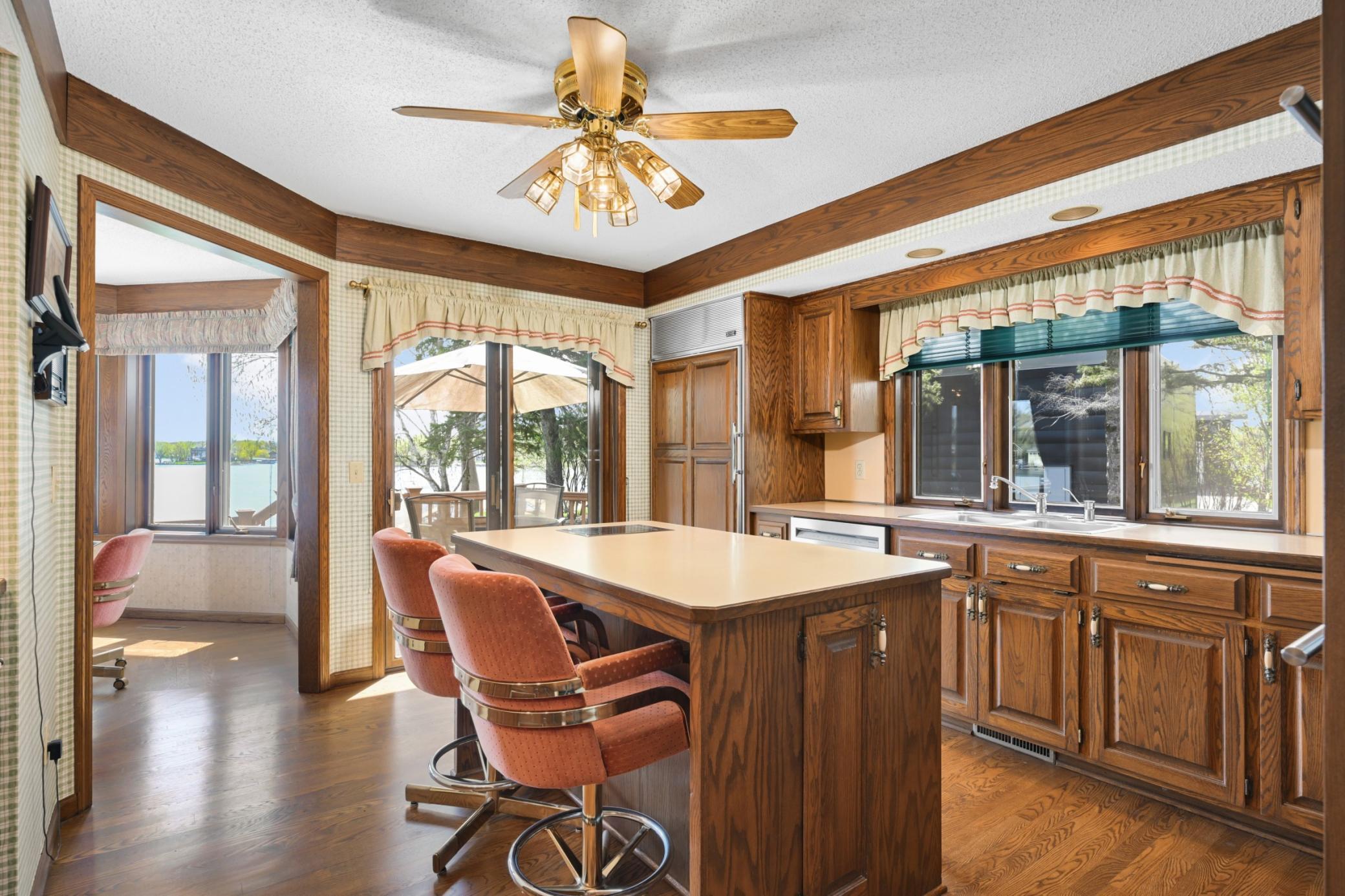 The kitchen flows directly to the lakeside dining nook and deck, keeping the water close to everyday life.