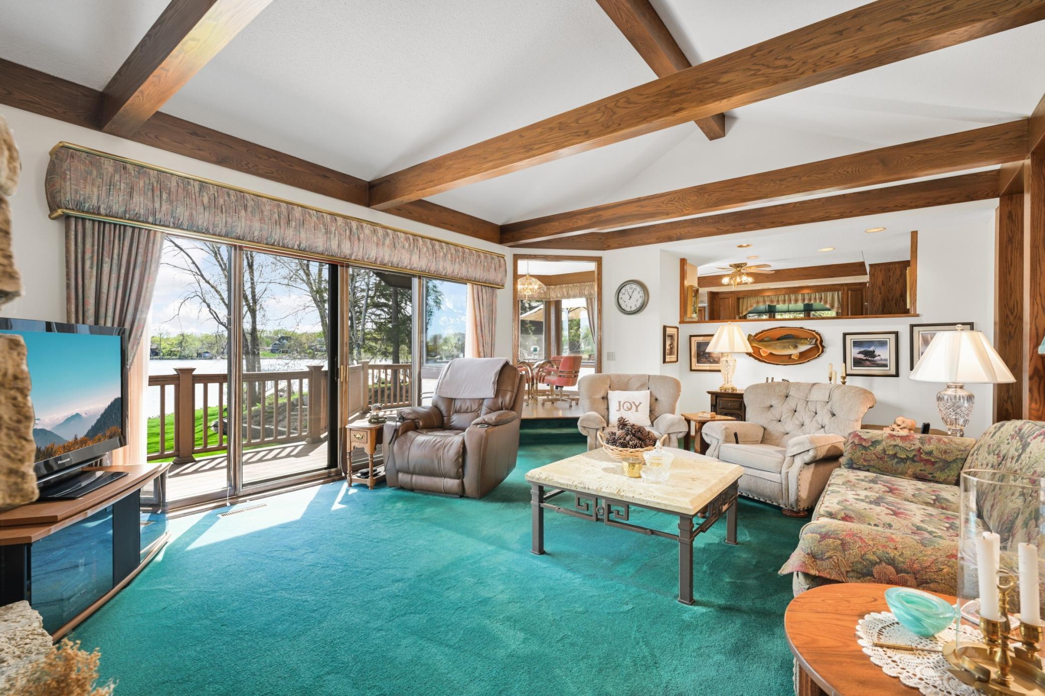 Vaulted ceilings, exposed beams and easy deck access create a comfortable lakeside gathering space.