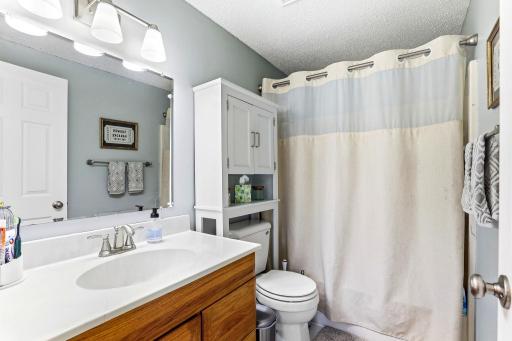Upper-level Full Bath features tile flooring, a full tub/shower and additional storage.