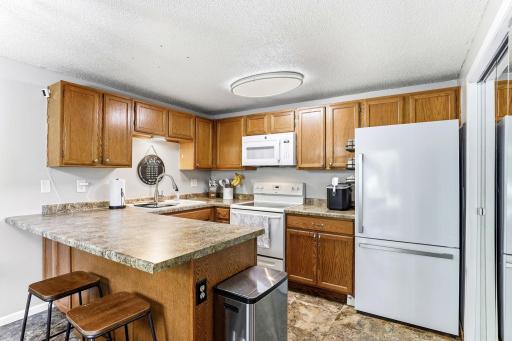 Updated countertops, plenty of cabinetry and a large peninsula make good use of the Kitchen space.