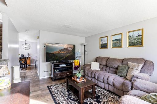 Comfortable Living Room with updated LVP flooring and an easy flow into the Dining Room and Kitchen.