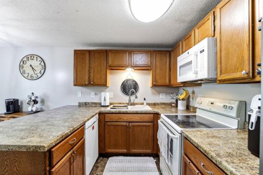 Plenty of counter workspace surrounds the Kitchen, with a newer Microwave (2025) and Refrigerator (2021).