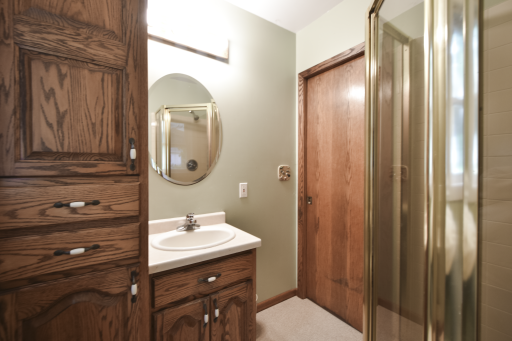 3/4 bath before you enter into the kitchen. Conveniently located in the rear of the house. Come in thru the garage to get cleaned up! Pocket door for space saving!