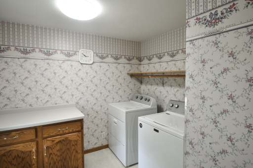 Main level laundry room. There is a folder area,shelf for storage and a bring window. Laundry room faces the front yard.
