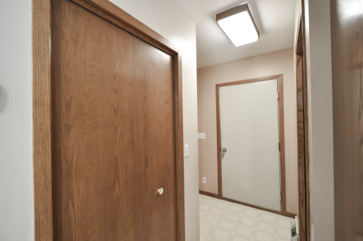 Bifold door to the left is a large pantry storage area. The 3/4 bath is to the right, the solid steel door goes to the garage. As you come in from the garage there is a place for a bench or coats/boots/shoes/bags etc. Very functional.