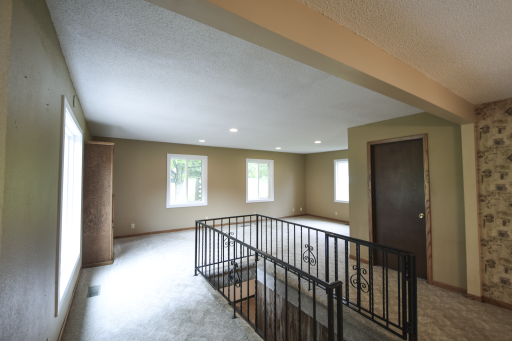 The stairs lead to a lower level that needs flooring and egressed windows to make legal bedroom. Could be a toy room, family room or install an egressed window for a large primary bedroom. The door that is closed was a bedroom but converted to office