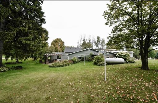 Another view of the back yard. The garage is very spacious with a 2 car garage area, work shop area and storage area. All with a new septic!