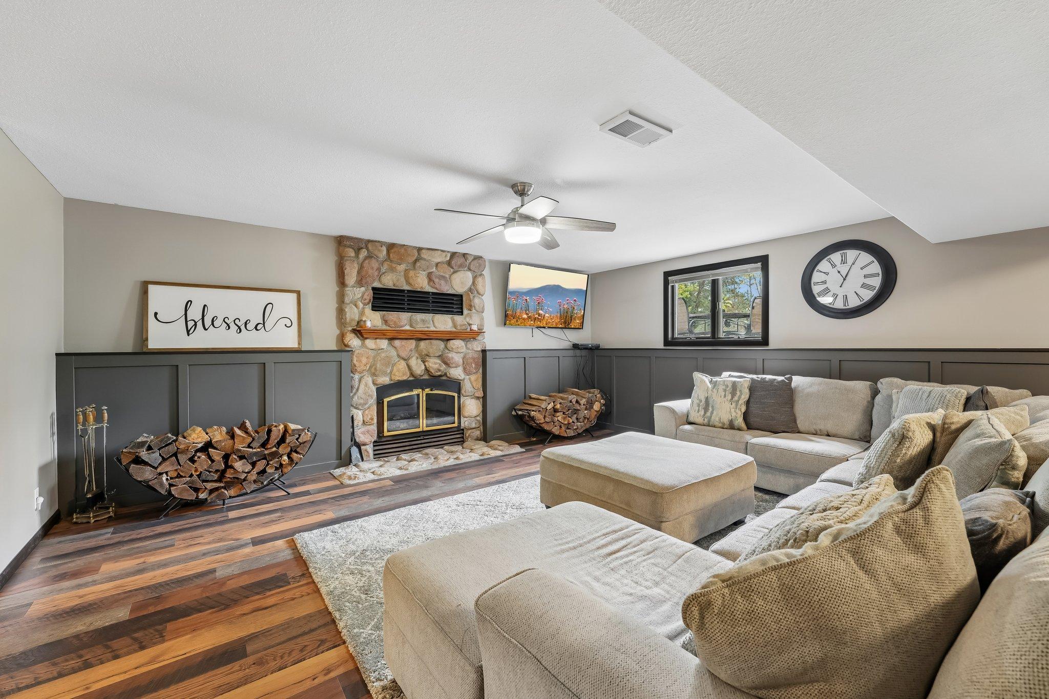 Lower level family room with wood fireplace and walkout to covered patio