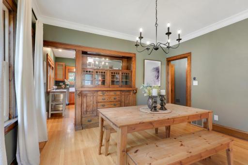 Beautiful built-in buffet with glass-front cabinetry adds character and storage to this inviting dining room.