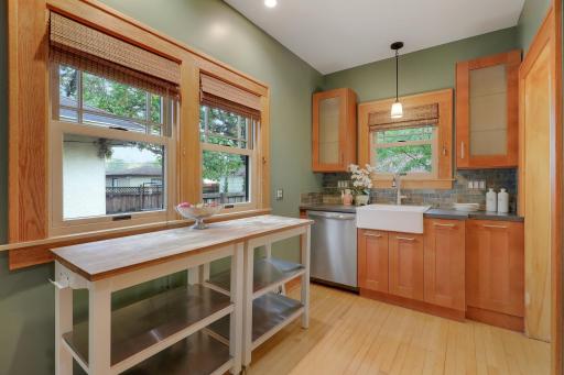 Extra counter space beneath the kitchen window offers a bright, convenient spot for meal prep.