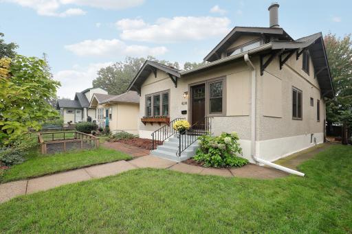 Charming curb appeal with classic architectural details, colorful gardens, and a welcoming front entry.