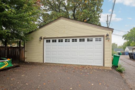 Two-car detached garage with convenient alley access and a paved approach.
