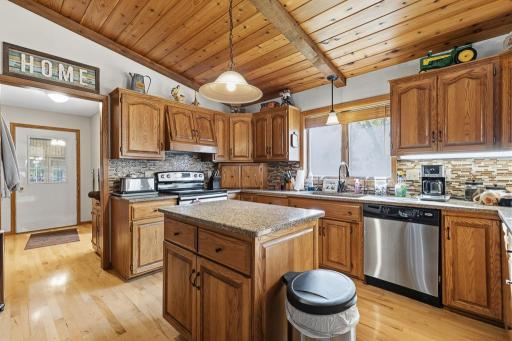 Hardwood flooring in the kitchen, laundry, and hallway to the sun room