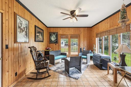 Naturally bright sun room on the back side of the home featuring access to the composite deck.