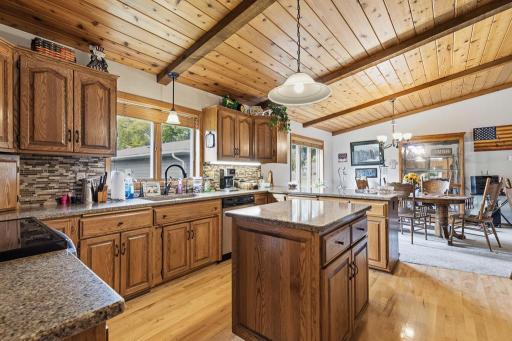 Stunning kitchen with center island, granite countertops, and adjacent dining room