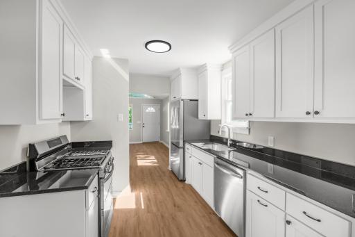 Fully remodeled kitchen complete with new stainless steel appliances and granite countertop with a tuck-under sink