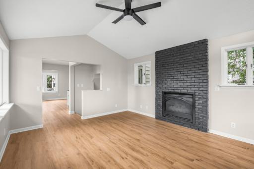 The family room boasts vaulted ceilings and a gas fireplace as well as new flooring throughout the main floor