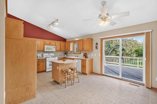 The light-filled kitchen showcases extensive storage and an open-concept design, blending style, efficiency, and timeless appeal.