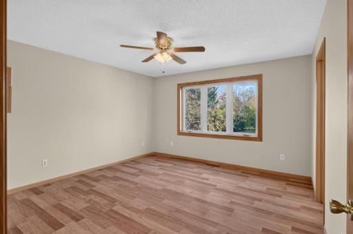 At the end of the day, escape to the primary suite, with a private en-suite bath complete with a corner whirlpool tub, creating a spa-like escape, and a separate walk-in closet for exceptional storage.