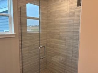 Primary Bathroom Tile Shower With Frameless Door