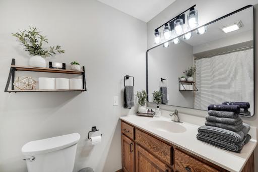 The updated main floor bathroom seen here is located between the garage and kitchen.