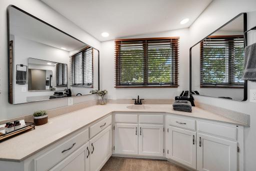 Updated En Suite bathroom with stone countertops, lots of cabinet space, and recent fixtures.