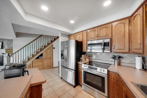 Stainless steel appliances throughout the kitchen, and a clever built in storage cabinets under the stairs that works great for games and misc items.
