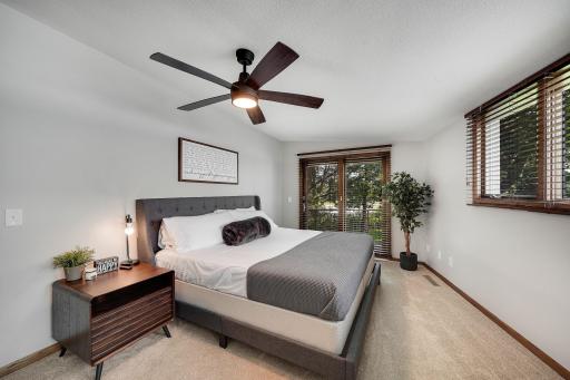 This is the primary bedroom with a private balcony overlooking the lake with maintenance free decking.
