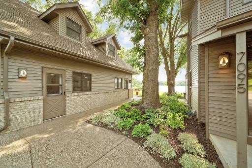 Gorgeous perennials that are well kept are on the walkway leading towards the lake.