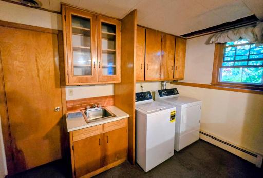 Washer/dryer included, storage cabinets. Door to water softener, gas water heater, & breaker box.