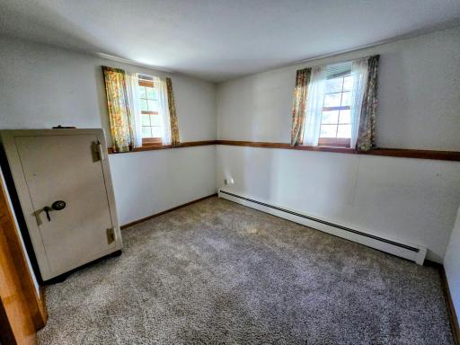 Lower level has convenient shelving around the room.