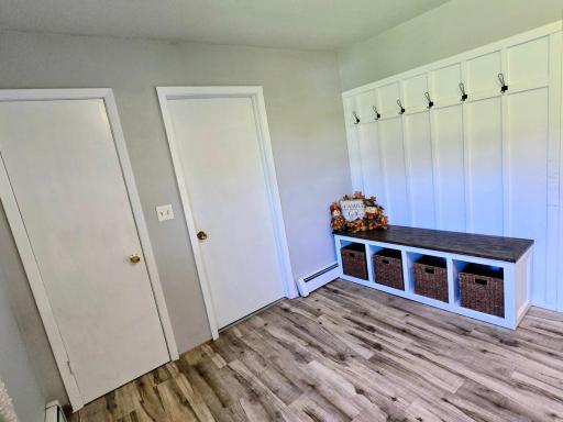 Door to closet and garage. Convenient sitting bench with hangers and storage.