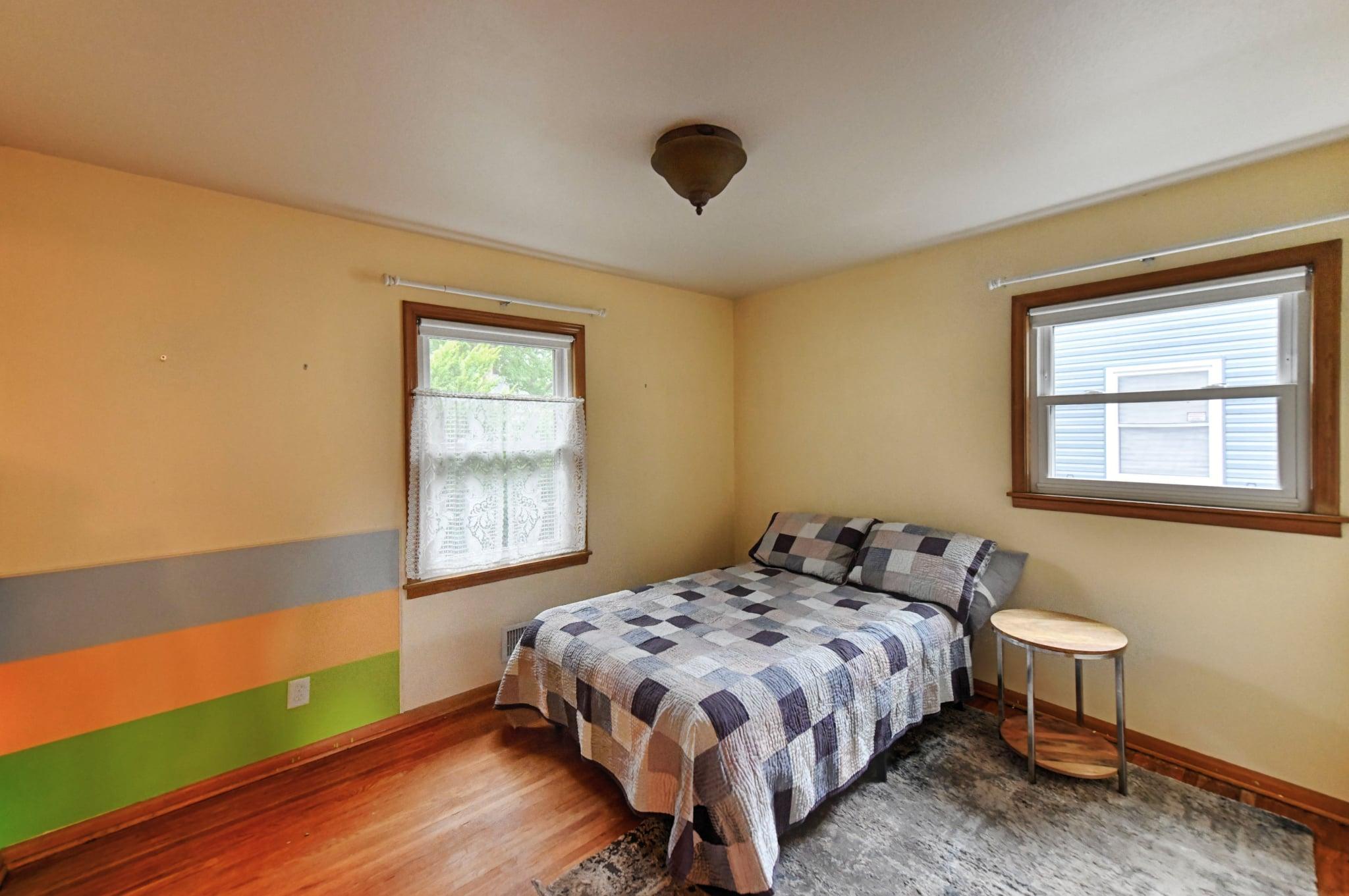 Larger of the two main floor bedrooms.