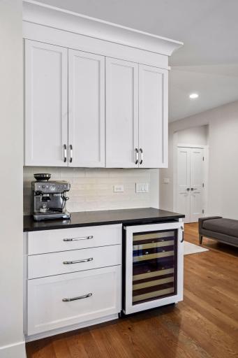 Wine fridge and additional cabinet space.
