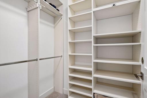 Primary suite is a private retreat with an en-suite bath and two generous walk-in closets.