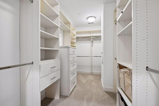 Primary suite is a private retreat with an en-suite bath and two generous walk-in closets.