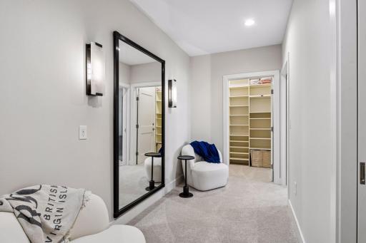 Primary suite is a private retreat with an en-suite bath and two generous walk-in closets.