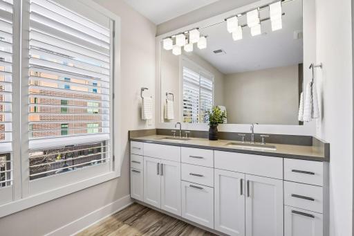 Spa-like primary bath features a separate soaking tub, double sinks, walk-in shower, and private toilet area.