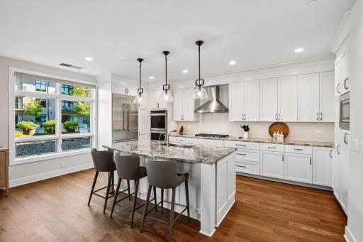 Kitchen features a sit-up bar perfect for casual dining.