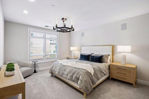 Primary suite is a private retreat with an en-suite bath and two generous walk-in closets.