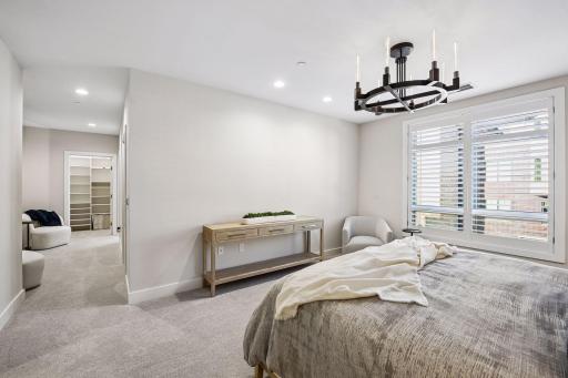 Primary suite is a private retreat with an en-suite bath and two generous walk-in closets.