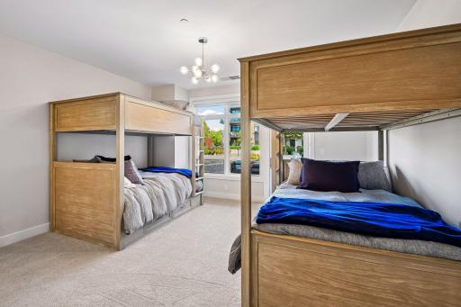 Bright and spacious secondary bedroom offers its own private patio, en-suite bathroom, generous walk-in closet, and plentiful windows for beautiful natural light.