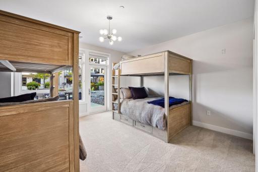 Bright and spacious secondary bedroom offers its own private patio, en-suite bathroom, generous walk-in closet, and plentiful windows for beautiful natural light.