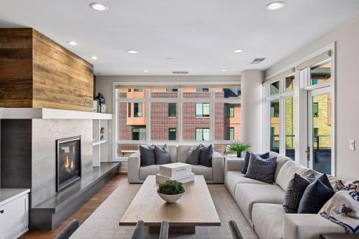 Expansive living room windows are enhanced with convenient motorized blinds.