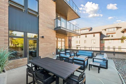Spacious patio features two seating areas and space for outdoor dining.