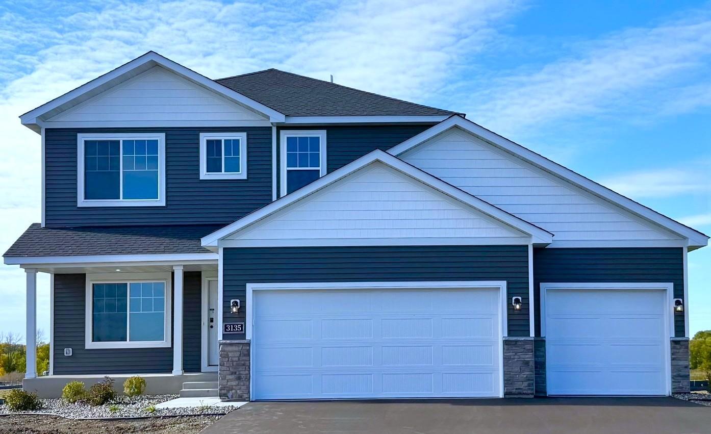 3135 Jandura Ave NE- New Construction Home ready for a Quick Move-in! Highlights include a 4 Bay Garage (934 sq. ft.) and Front Porch located on a Walkout Homesite! Sod will be installed soon.