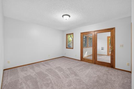 Bedroom #1 on the upper level featuring double closets and a private sun room