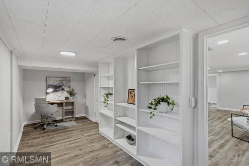 This lower level third bedroom is staged as an office, but can easily become a cozy bedroom with built in shelving and a separate walk in closet