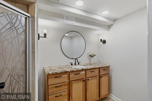 Lower level bathroom with new lights, mirror and updated vanity